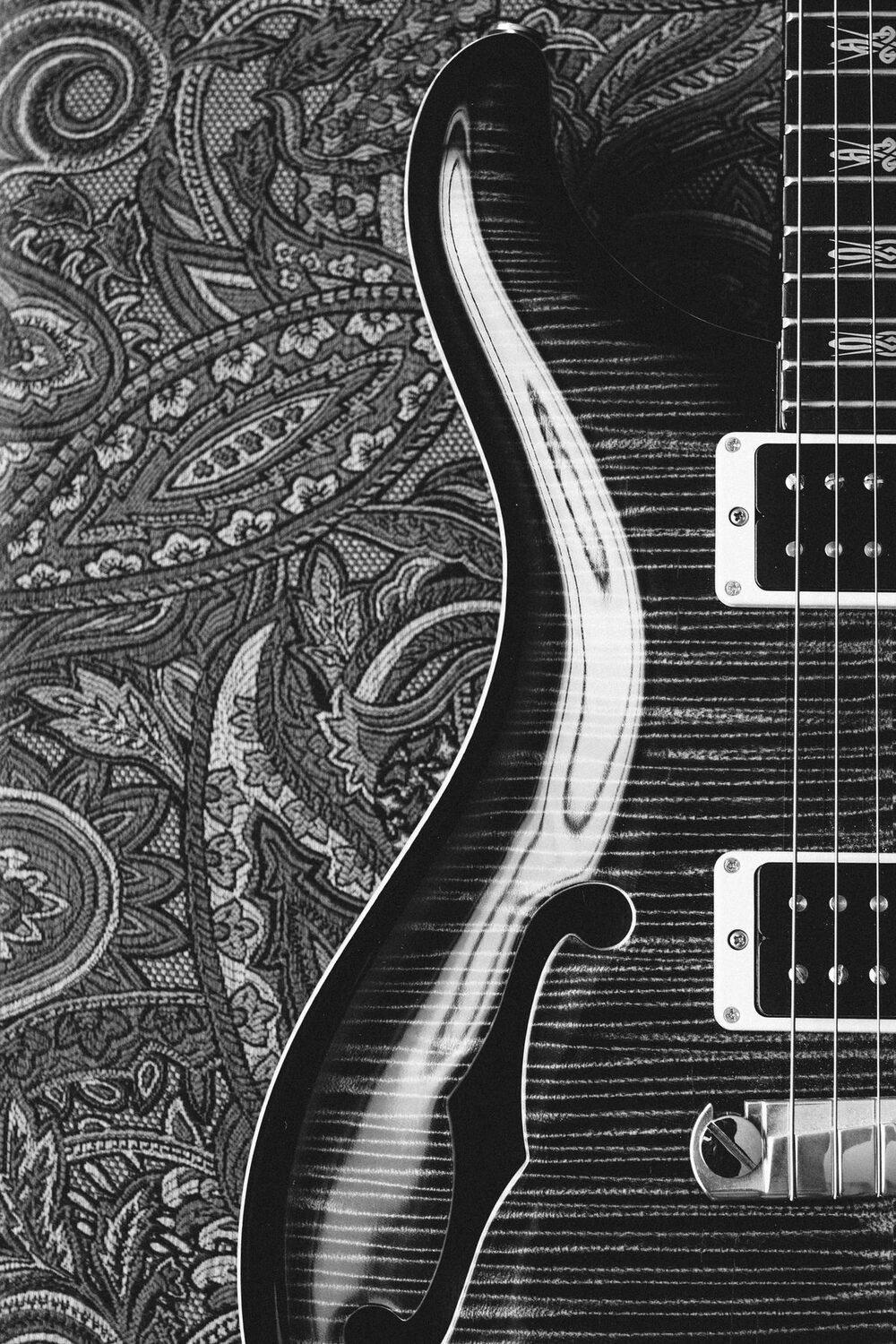 Close-up of a carved guitar top and its pickups